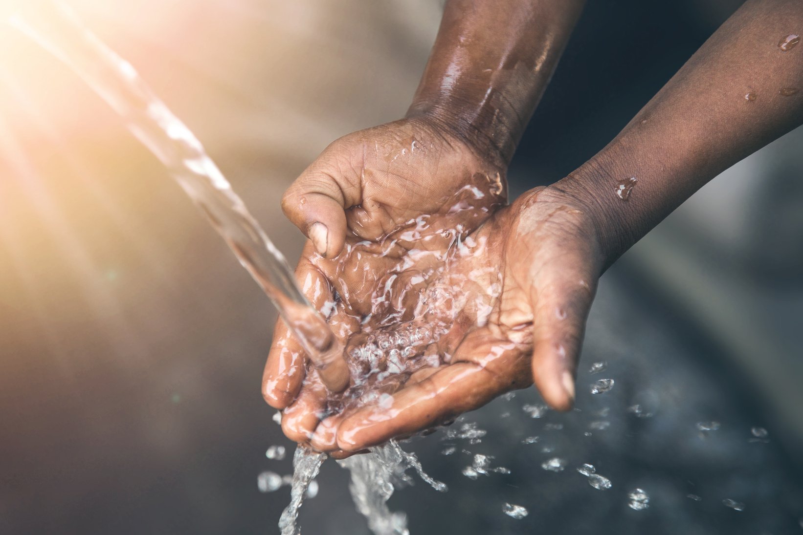 Hands of poor child - scoop drinking water, Africa